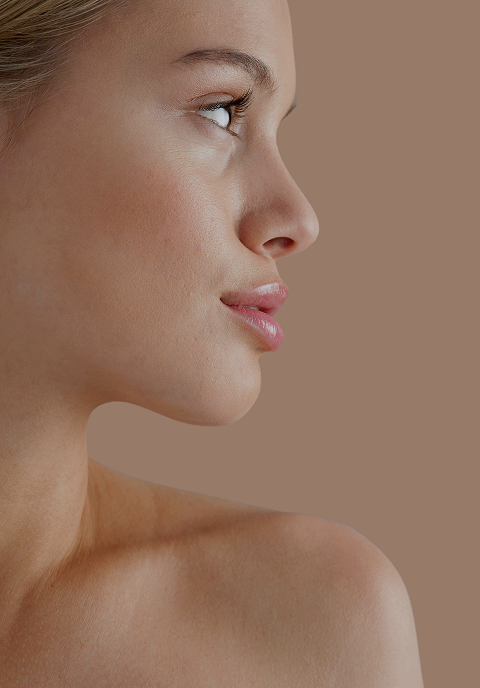 A woman in profile, her neck and bare shoulder in view
